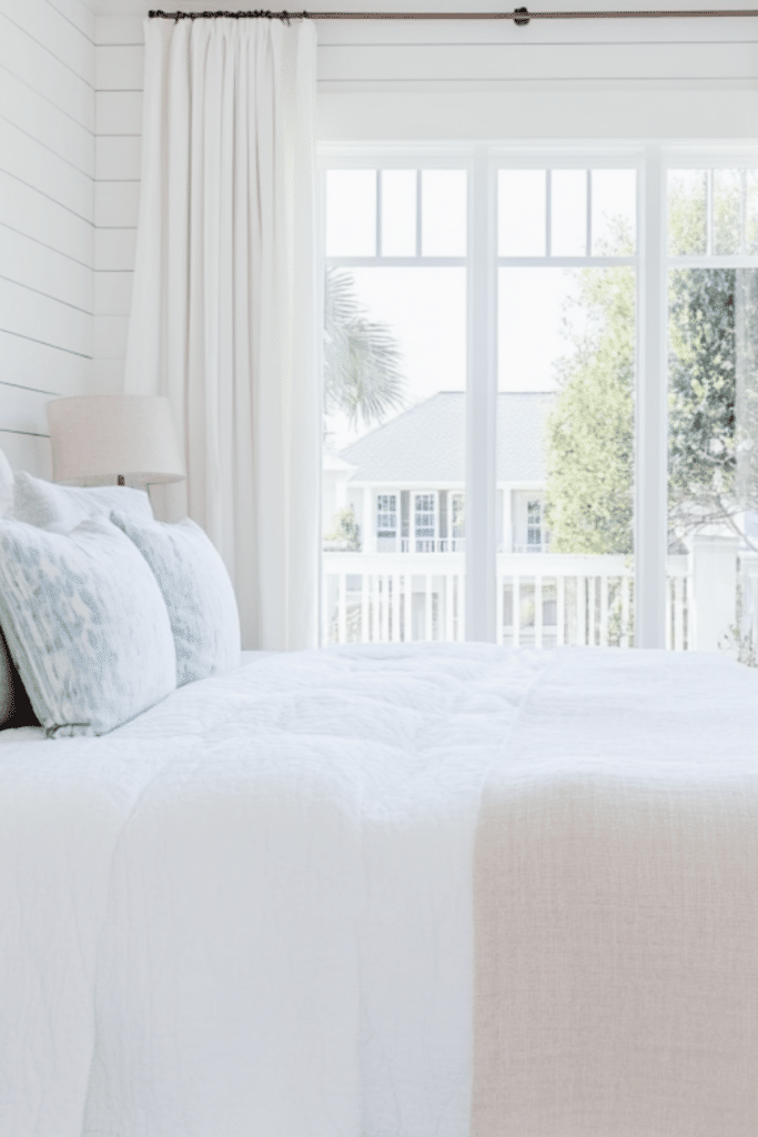 Cozy Coastal Bedroom with Light Curtains and White Bedding